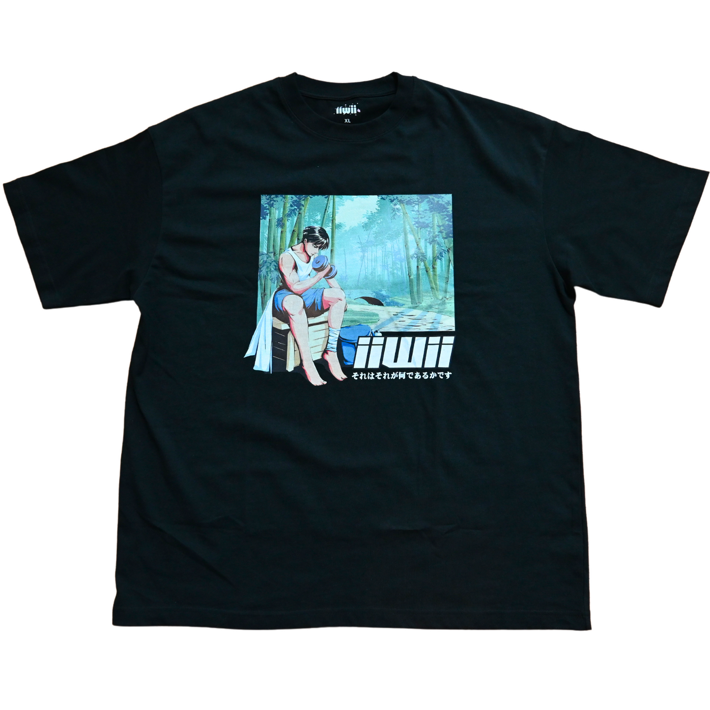 A black oversized t-shirt with a graphic print in the center, featuring a person sitting in a bamboo forest.